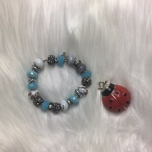 Faux gem, 22 charm, silver tone bracelet, 10 1/2”.